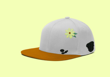 light grey cap designed to look like a duck with a flower on its head